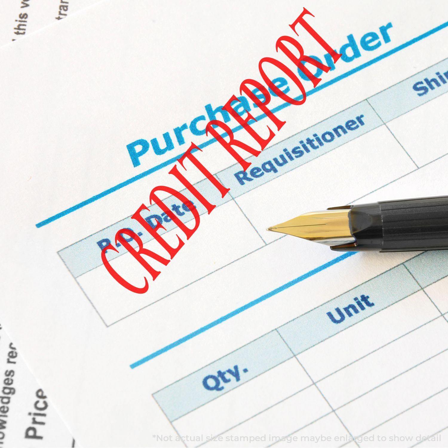 Slim Pre-Inked Credit Report Stamp in red ink on a purchase order document with a fountain pen nearby.