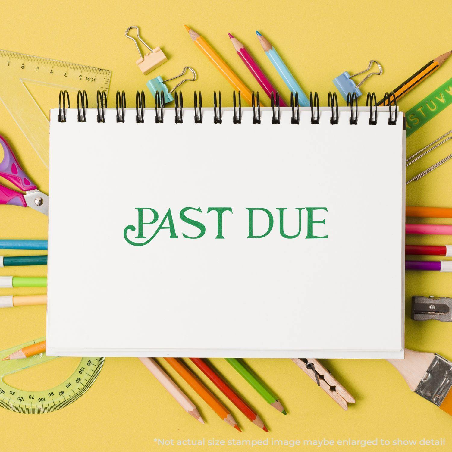 Large Self Inking Curley Past Due Stamp on a white notepad surrounded by colorful stationery on a yellow background.