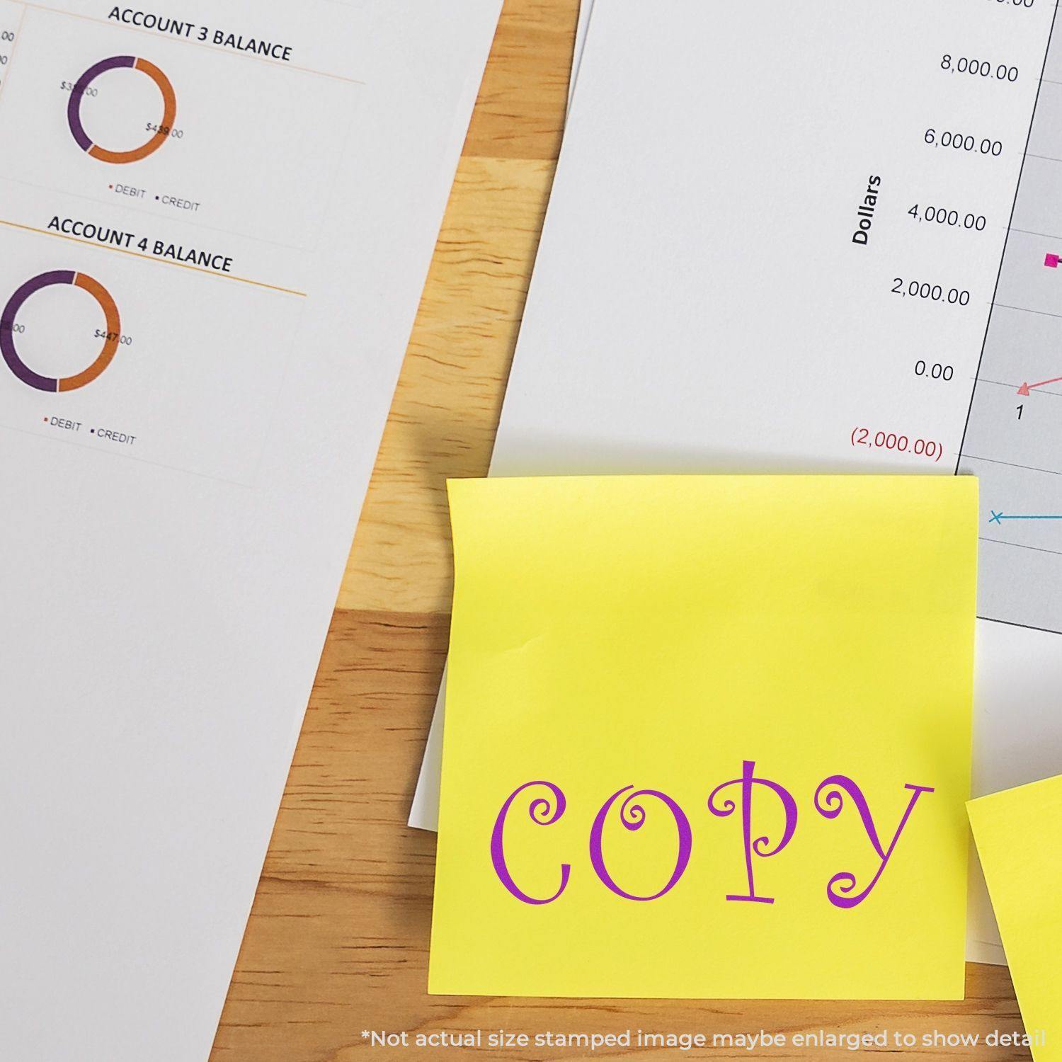 Curly Copy Rubber Stamp used on a yellow sticky note placed on a desk with financial documents and charts in the background.