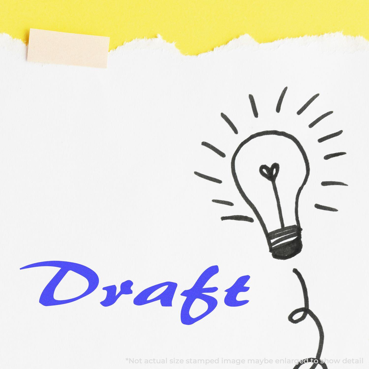 Large Cursive Draft Rubber Stamp used on white paper with a lightbulb sketch, showcasing the word Draft in blue cursive.