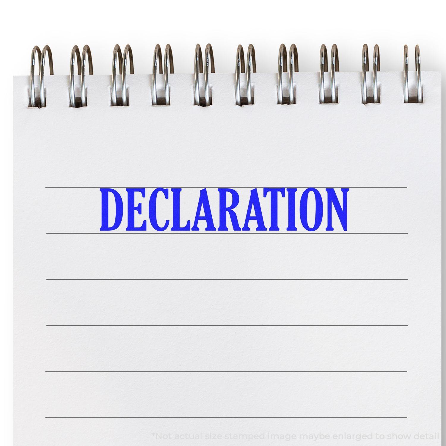 A notebook with the word DECLARATION stamped in blue using the Declaration Rubber Stamp.