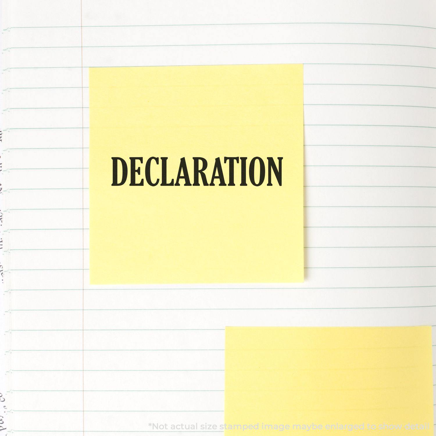 Declaration Rubber Stamp imprint on a yellow sticky note placed on a lined notebook page.