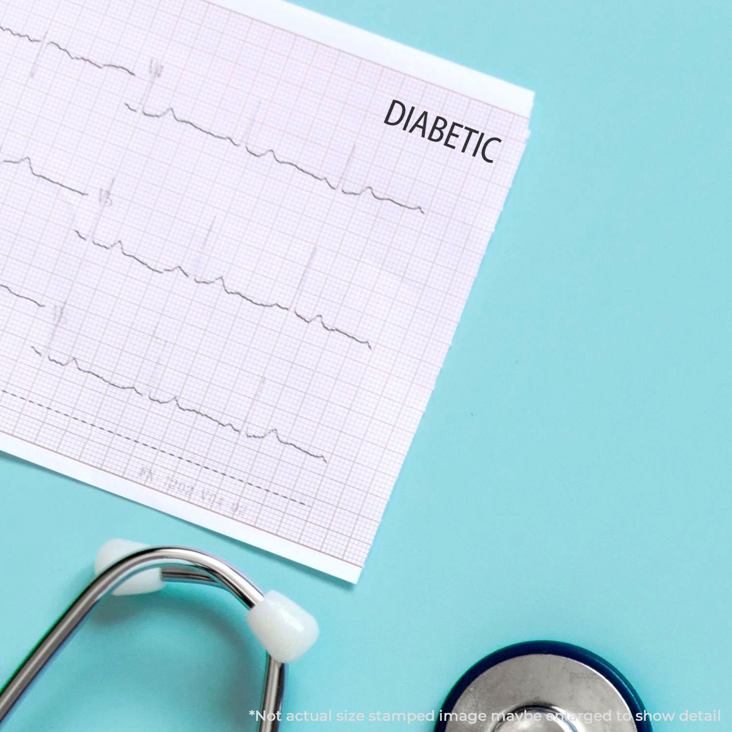 A medical chart stamped with DIABETIC using the Large Diabetic Rubber Stamp, next to a stethoscope on a light blue surface.