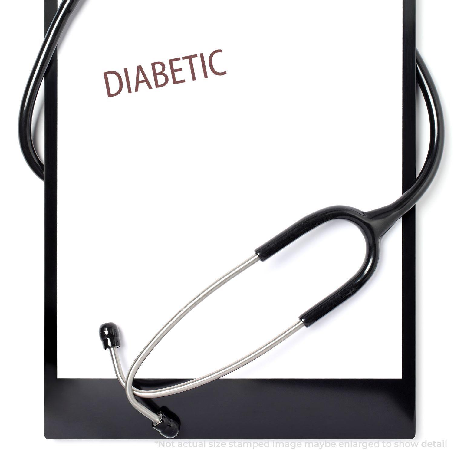 Clipboard with DIABETIC stamped in red using the Large Diabetic Rubber Stamp, with a stethoscope draped over the top.