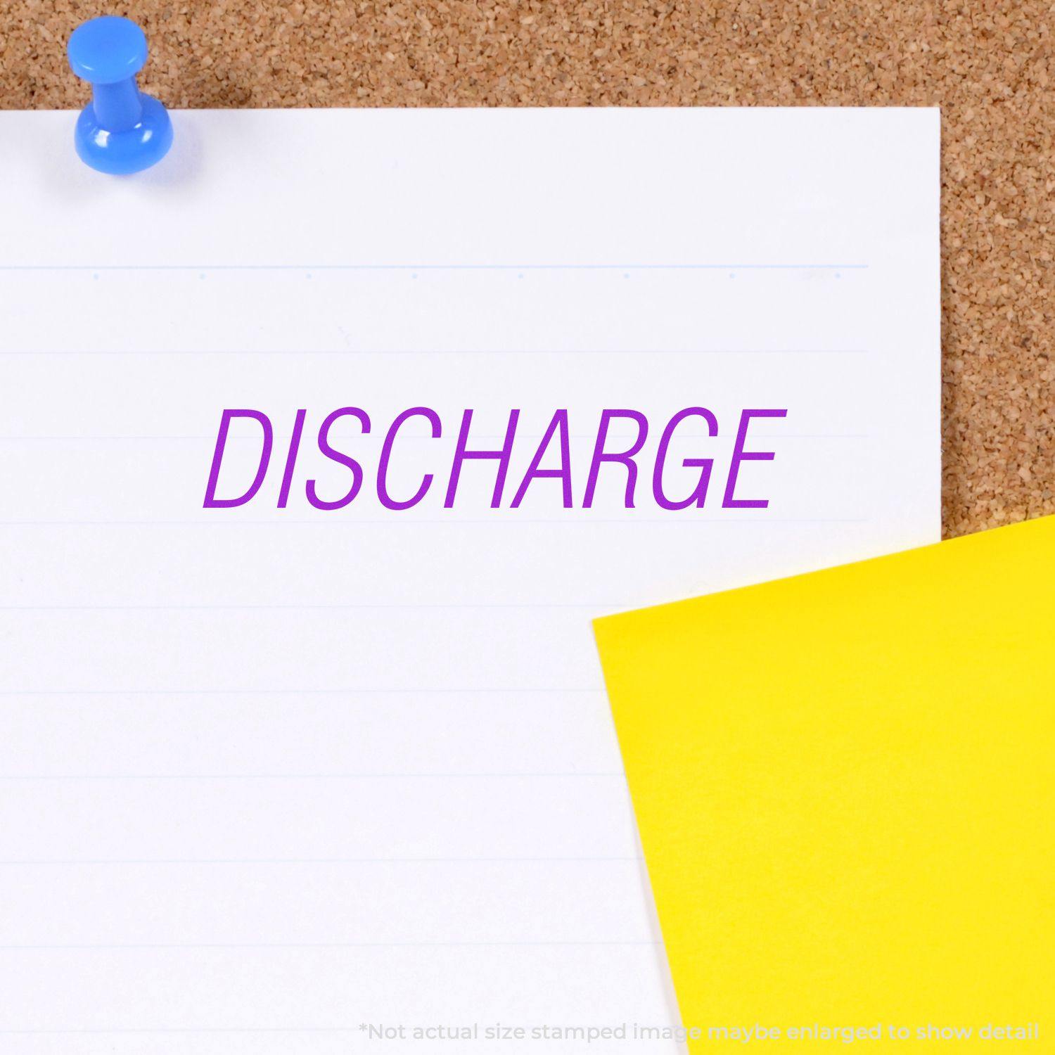 Discharge Rubber Stamp in purple ink on white paper pinned to a corkboard with a blue pushpin and a yellow sticky note.