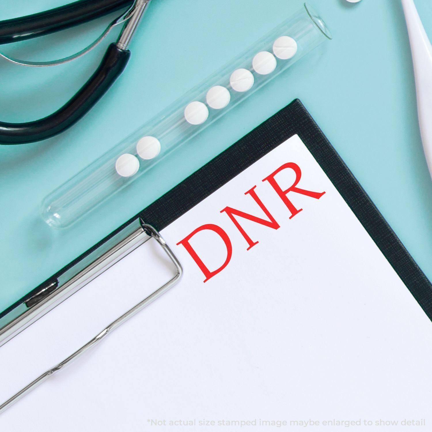 Clipboard with DNR stamped in red using the Large DNR Rubber Stamp, surrounded by medical tools on a light blue background.