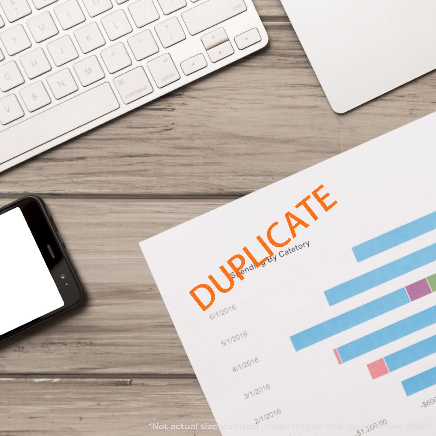 A Large Duplicate Rubber Stamp marks a document on a desk with a keyboard, smartphone, and laptop.