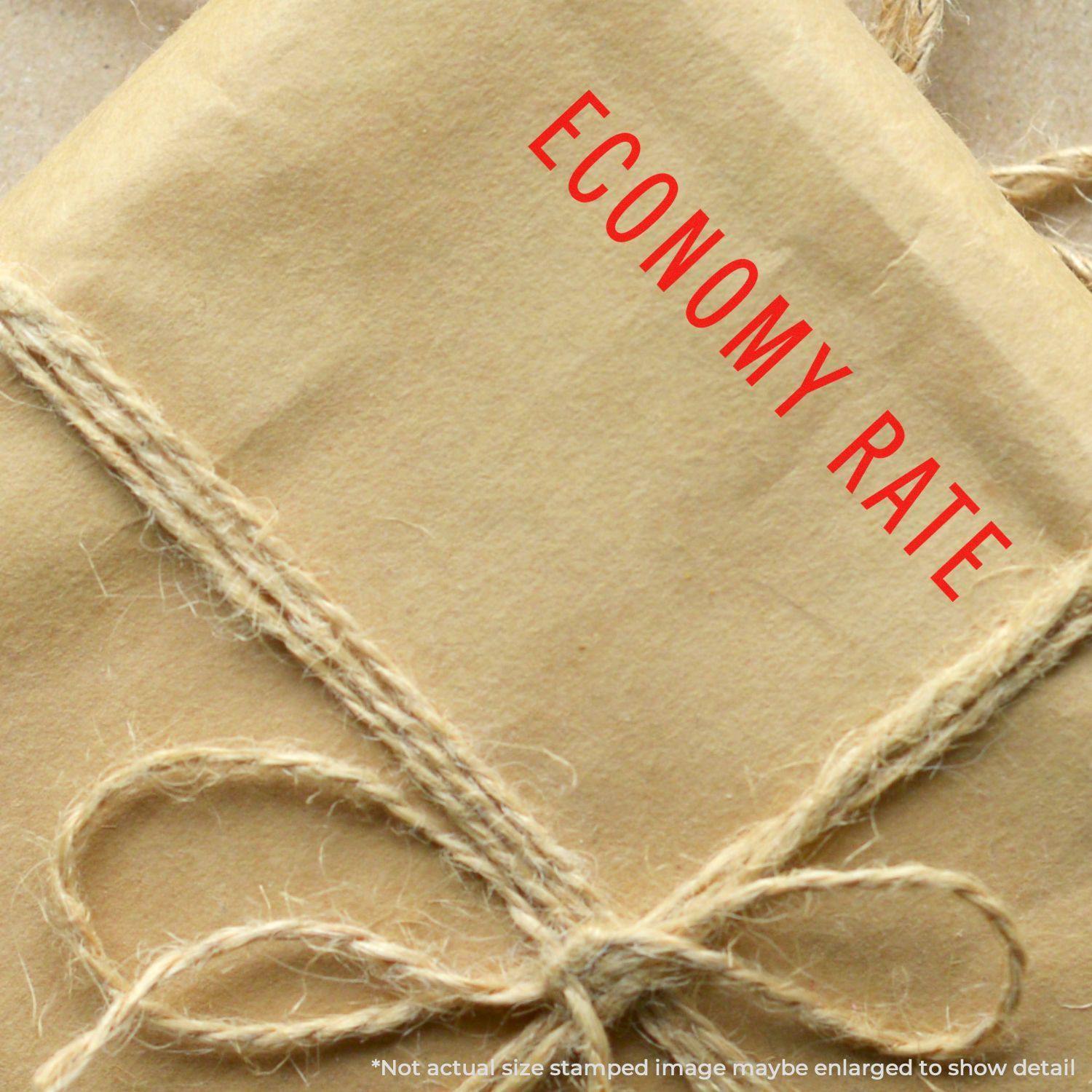 A brown paper package tied with twine, stamped with ECONOMY RATE in red using the Economy Rate Rubber Stamp.