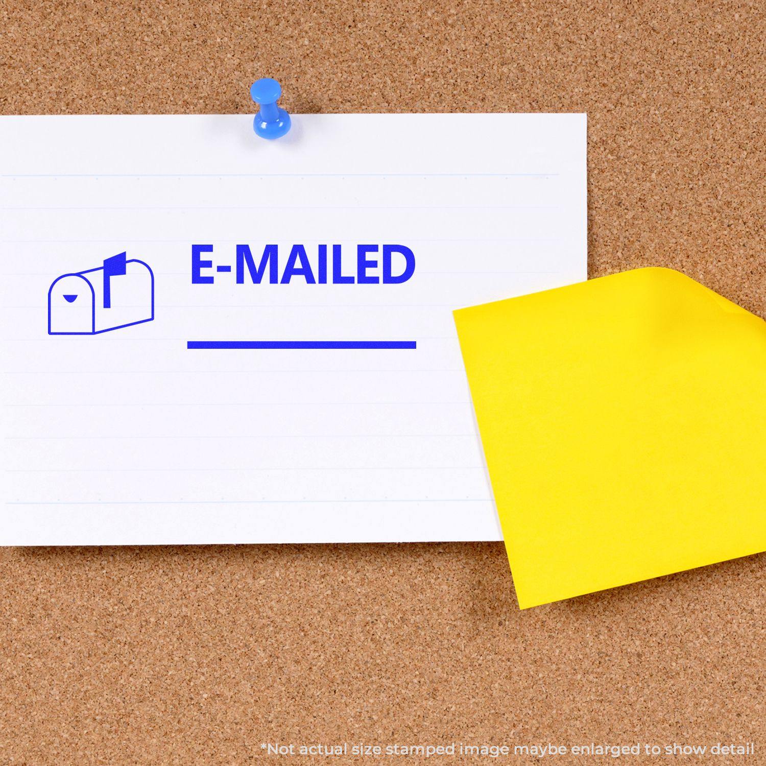 A corkboard with a note stamped E-MAILED using the Emailed with Mailbox Rubber Stamp, pinned with a blue pushpin and a yellow sticky note.