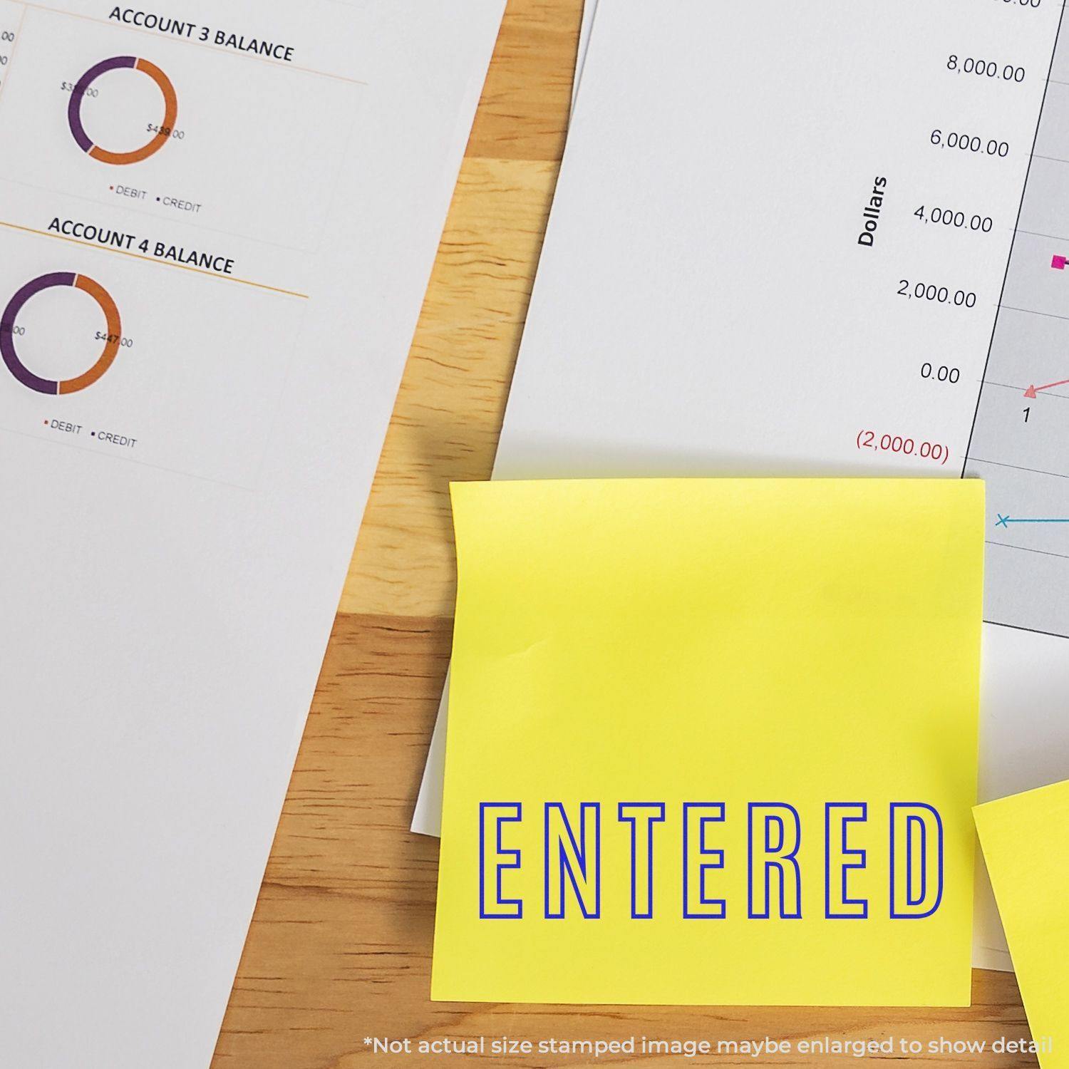 Large Pre-Inked Entered Outline Stamp used on a yellow sticky note, placed on a desk with financial documents in the background.