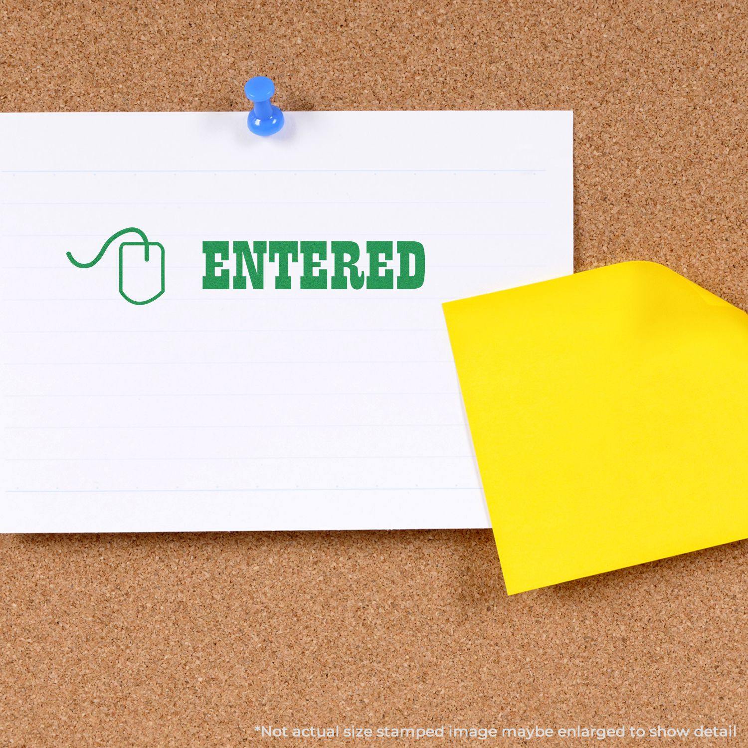 A corkboard with a white paper stamped ENTERED in green using the Entered with Mouse Rubber Stamp, pinned with a blue pushpin.