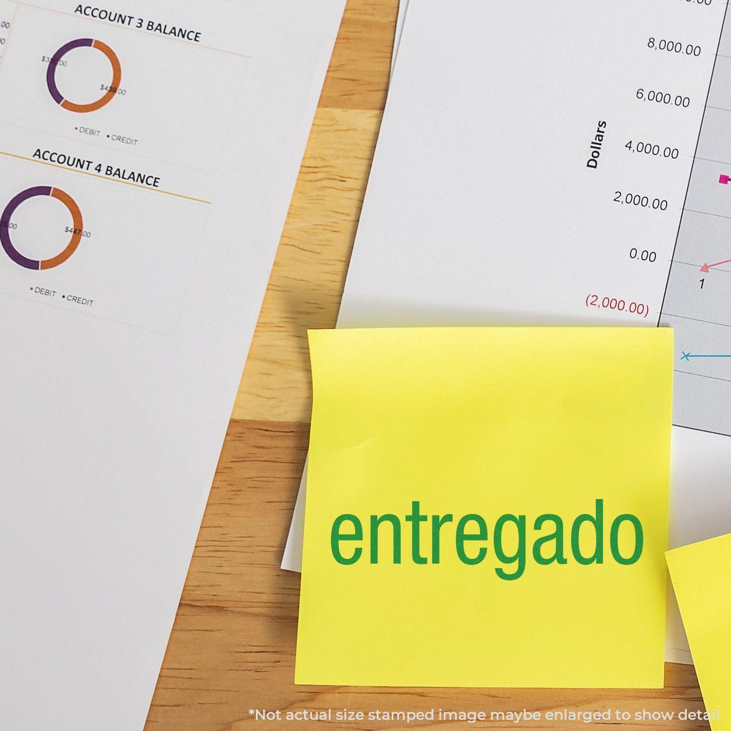 A yellow sticky note with entregado stamped on it using the Entregado Rubber Stamp, placed on a desk with financial documents.