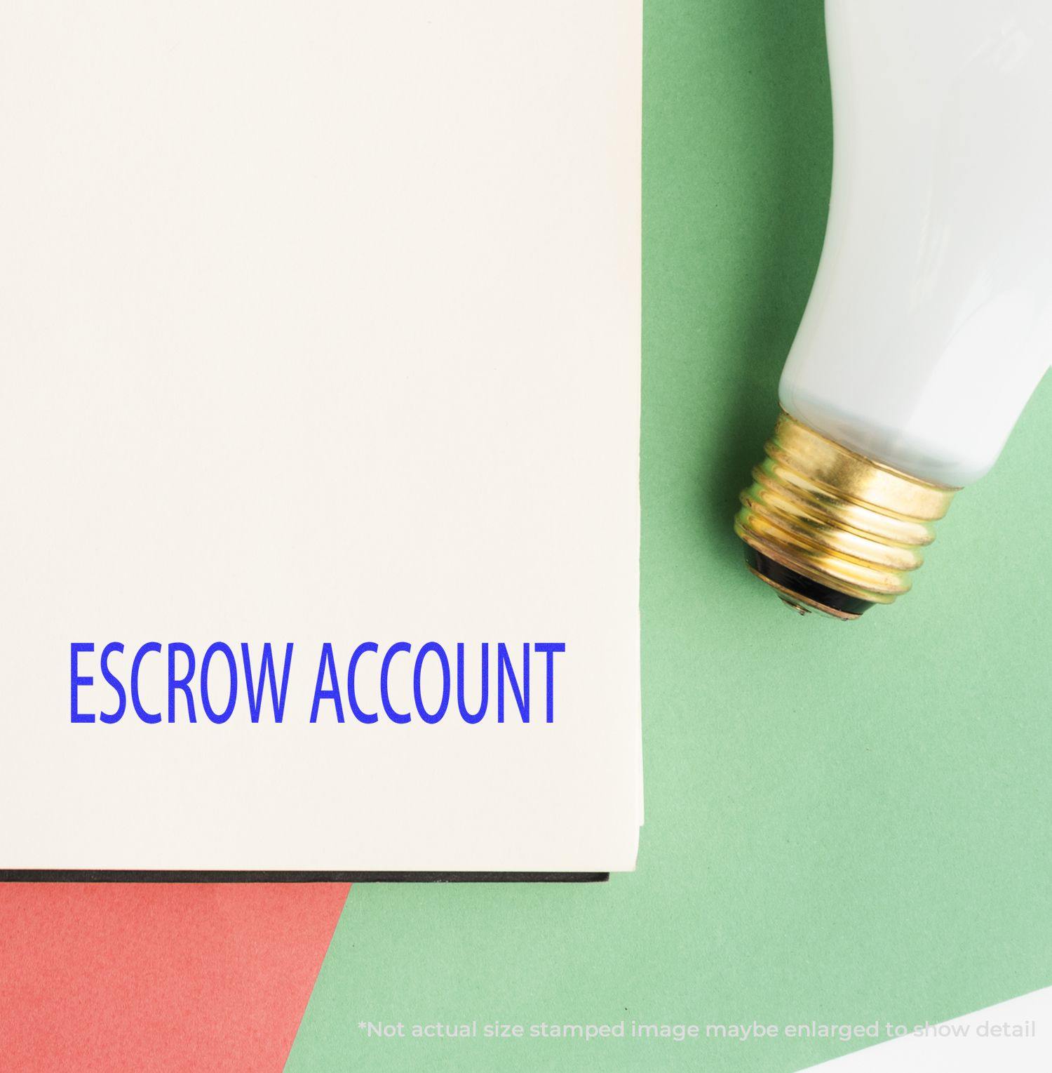 Large Escrow Account Rubber Stamp imprint on a white paper, placed on a green and red background with a light bulb nearby.