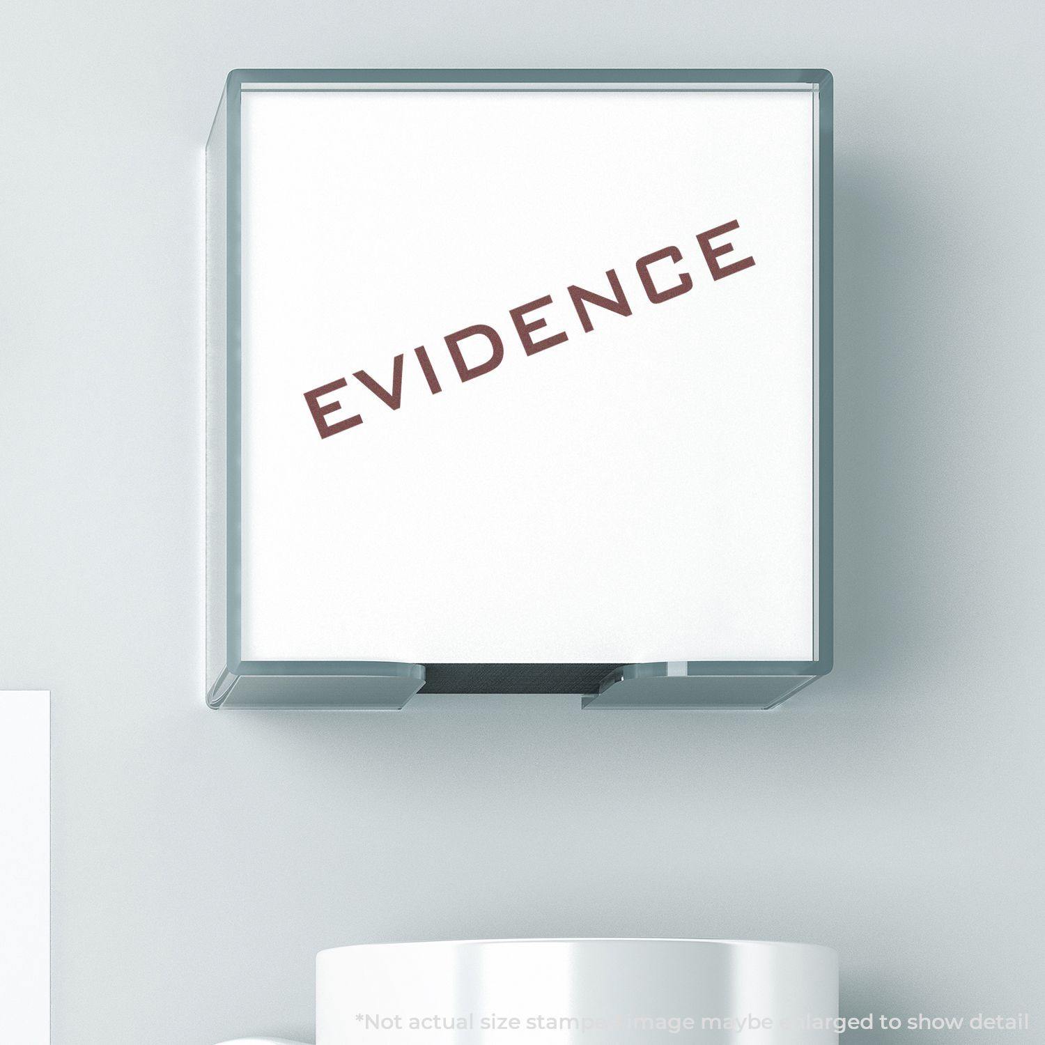 Self Inking Evidence Stamp in use, showing the word EVIDENCE stamped in red on a white surface.