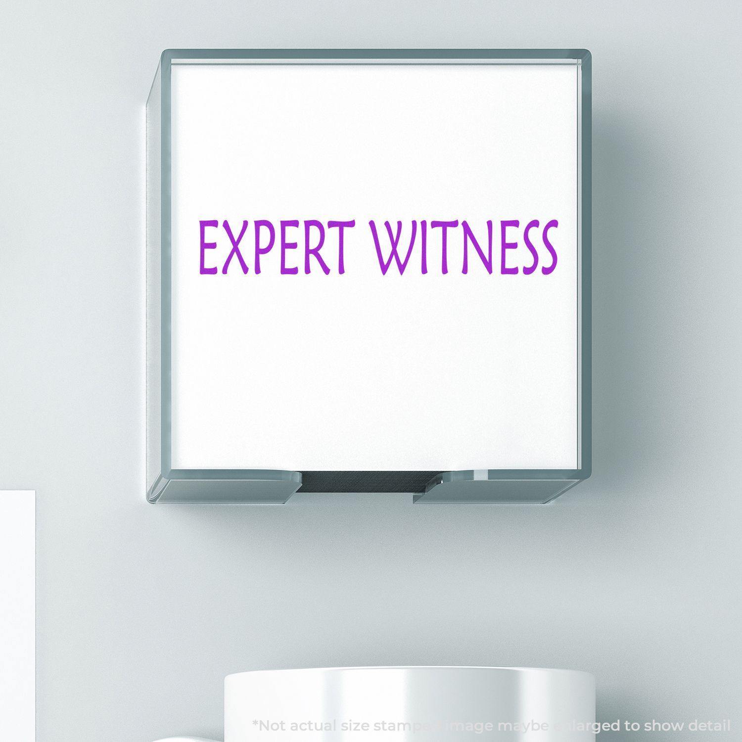 Large Self Inking Expert Witness Stamp in use, showing the text EXPERT WITNESS in purple on a white background.