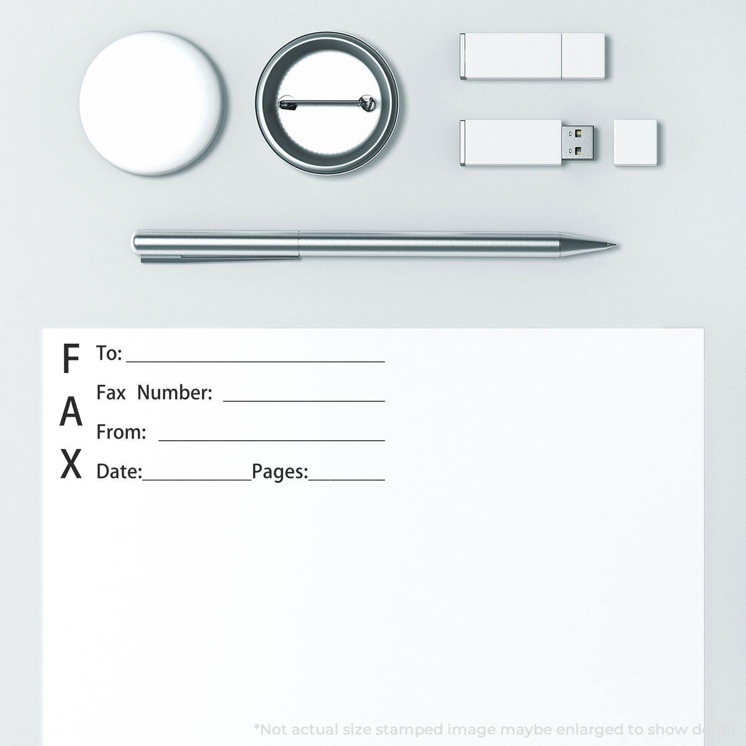 A desk with a Self Inking Fax It 1 Stamp, a pen, USB drives, and a paper with fax details.