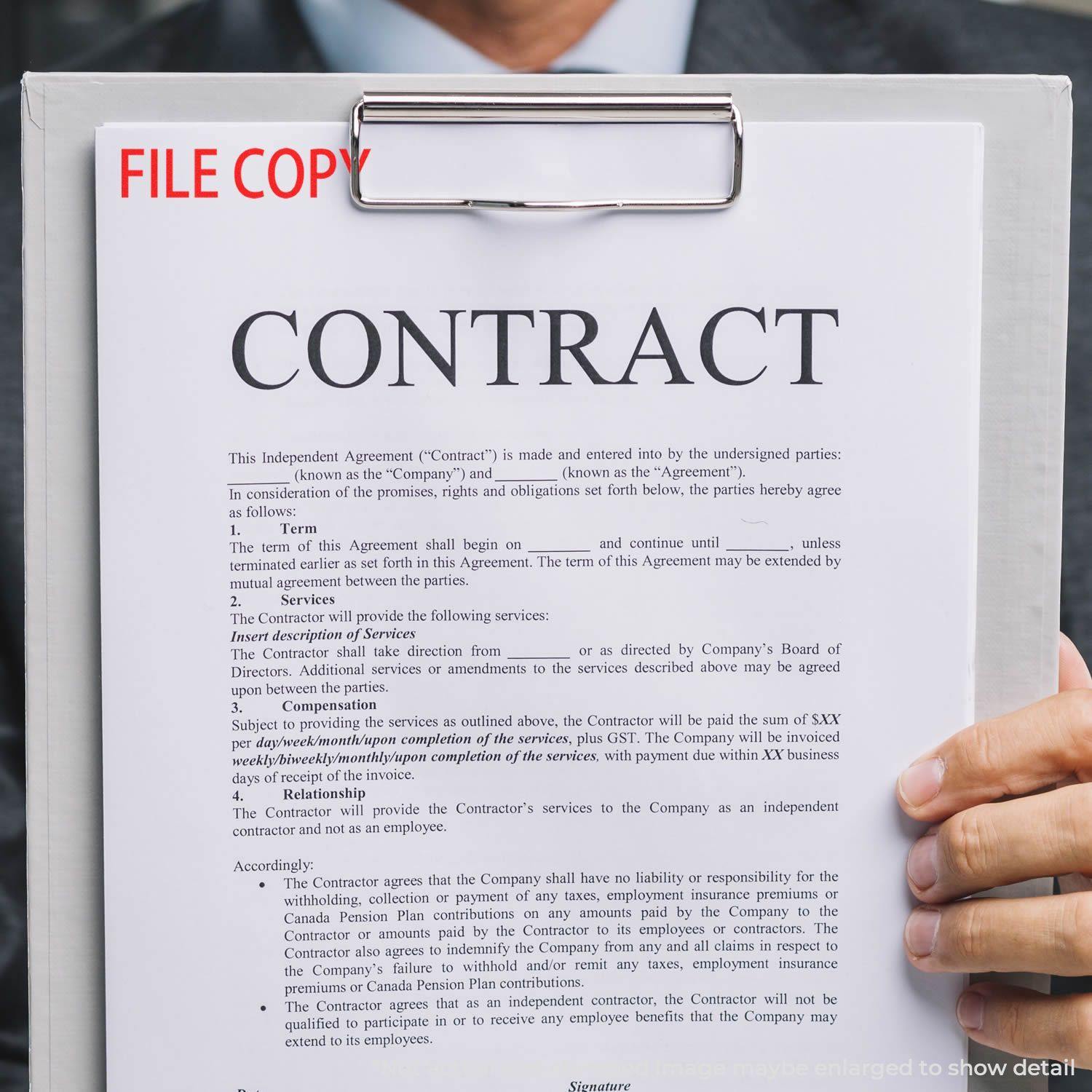 A clipboard with a contract stamped FILE COPY using a Self Inking File Copy Stamp, held by a person in a suit.