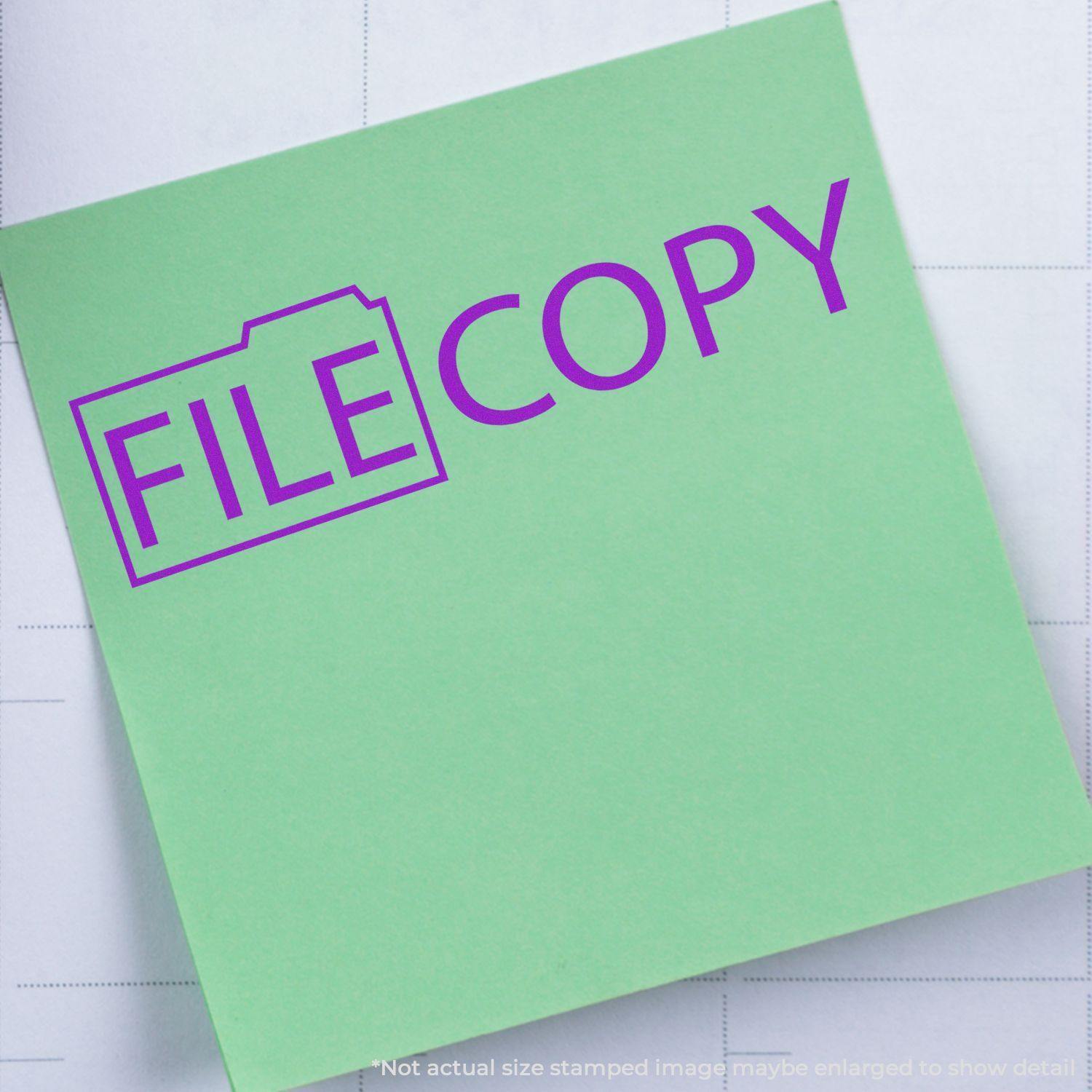 Green paper stamped with File Copy with Folder Rubber Stamp in purple, featuring a folder icon around the word File.