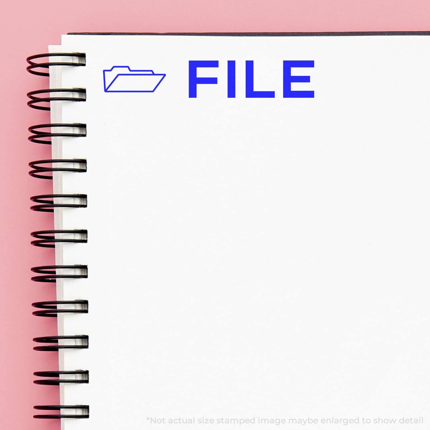 A notebook with a blue FILE stamp and envelope icon from the Large Pre-Inked File with Envelope Stamp on a pink background.