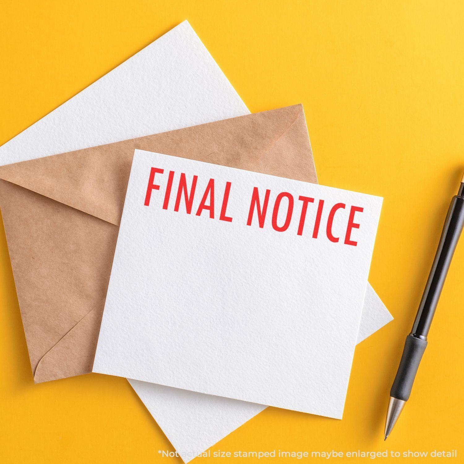 Final Notice Rubber Stamp used on a white card placed on a brown envelope with a pen nearby, against a yellow background.