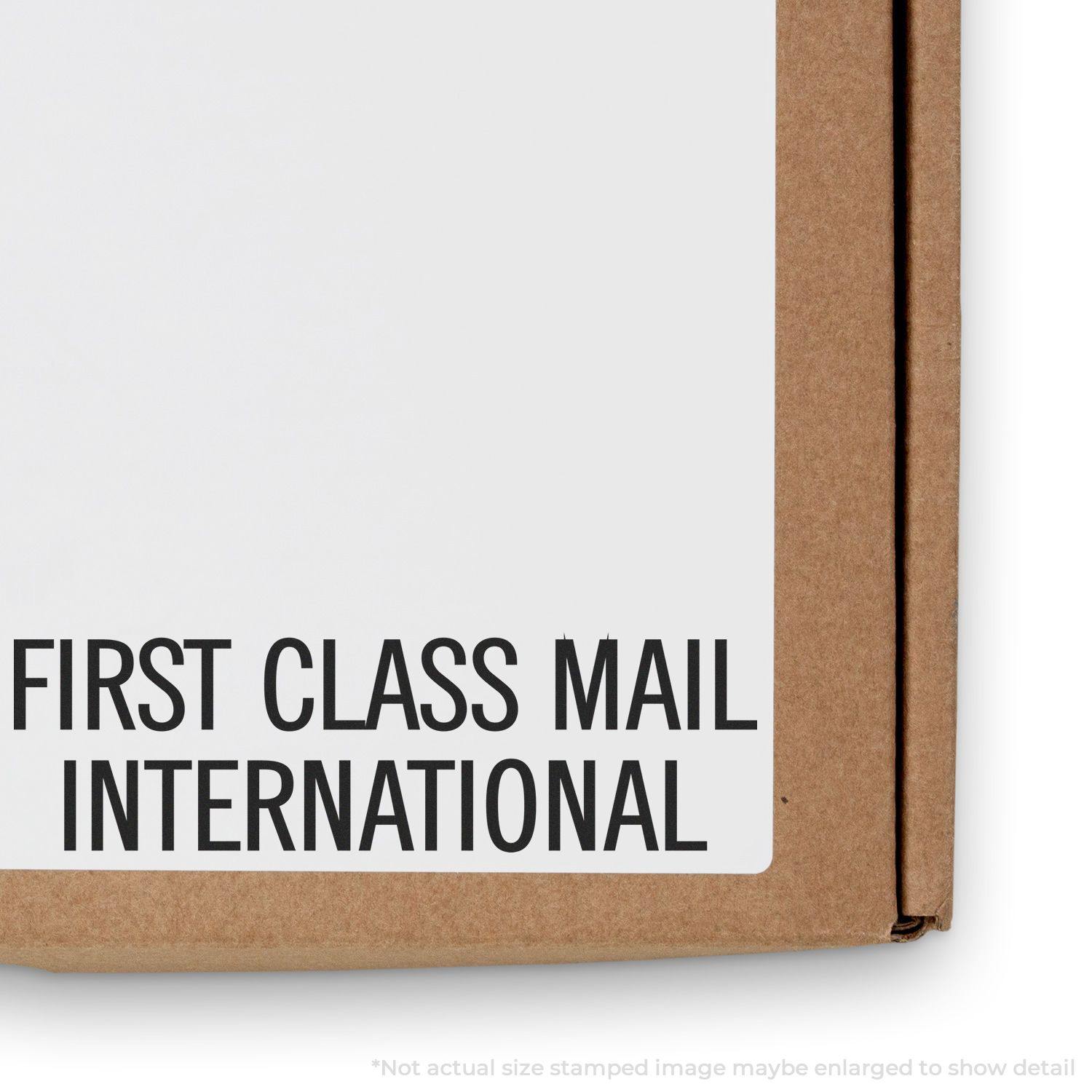 Large Self Inking First Class Mail International Stamp used on a cardboard box, showing clear and bold text.