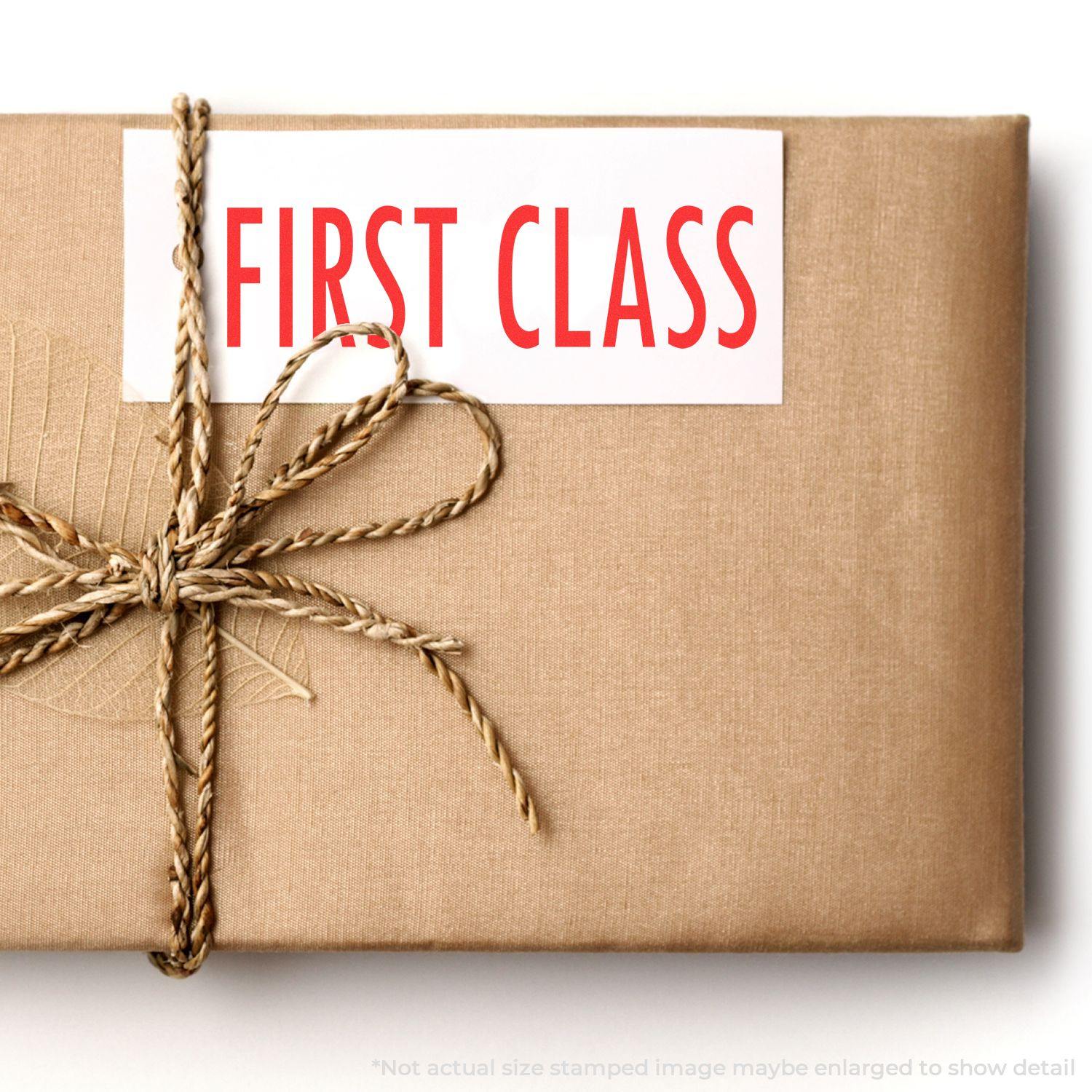 A brown package tied with twine, stamped with FIRST CLASS using the Large First Class Rubber Stamp.