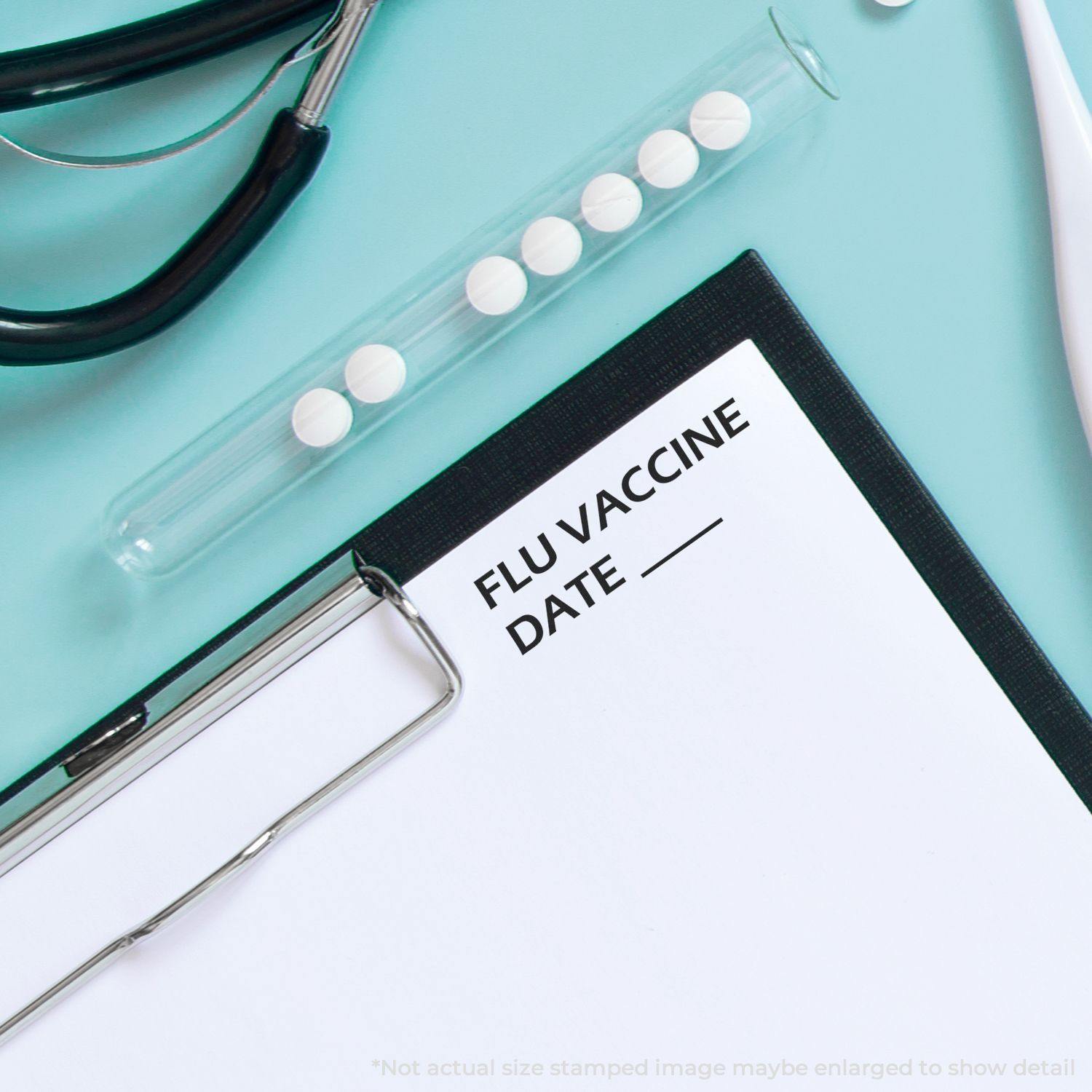 Slim Pre-Inked Flu Vaccine Date Stamp on a clipboard next to a stethoscope and a test tube with pills on a blue background.