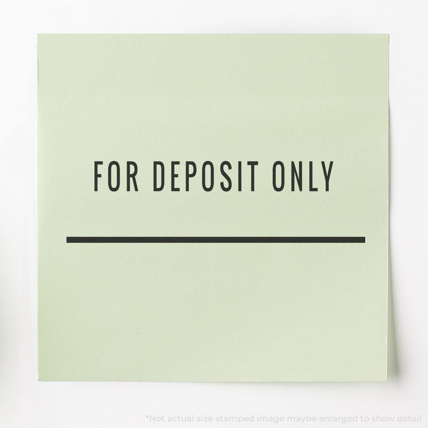 Image of a green paper stamped with For Deposit Only and a line below it using the For Deposit Only with Line Rubber Stamp.