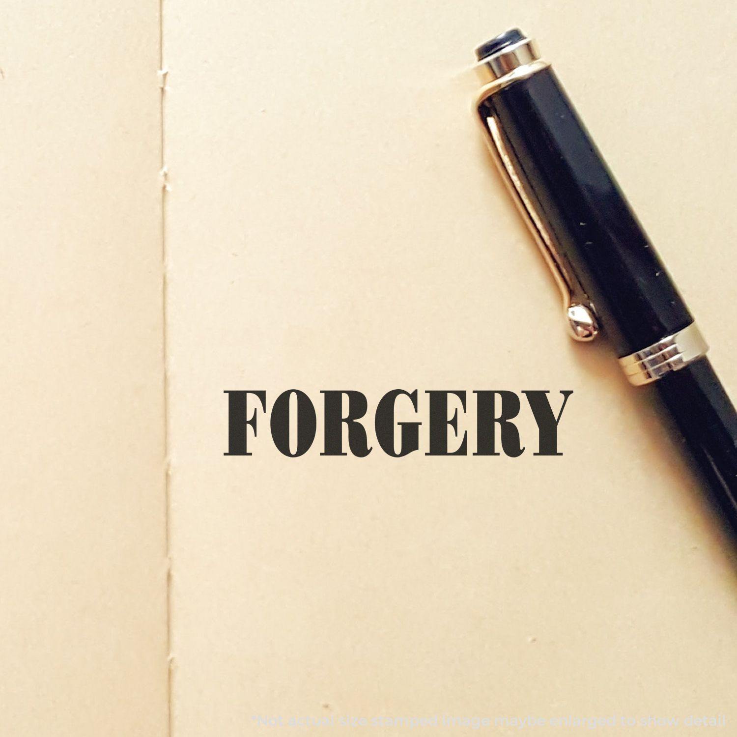 Forgery Rubber Stamp impression on a beige paper with a black pen placed on the right side.