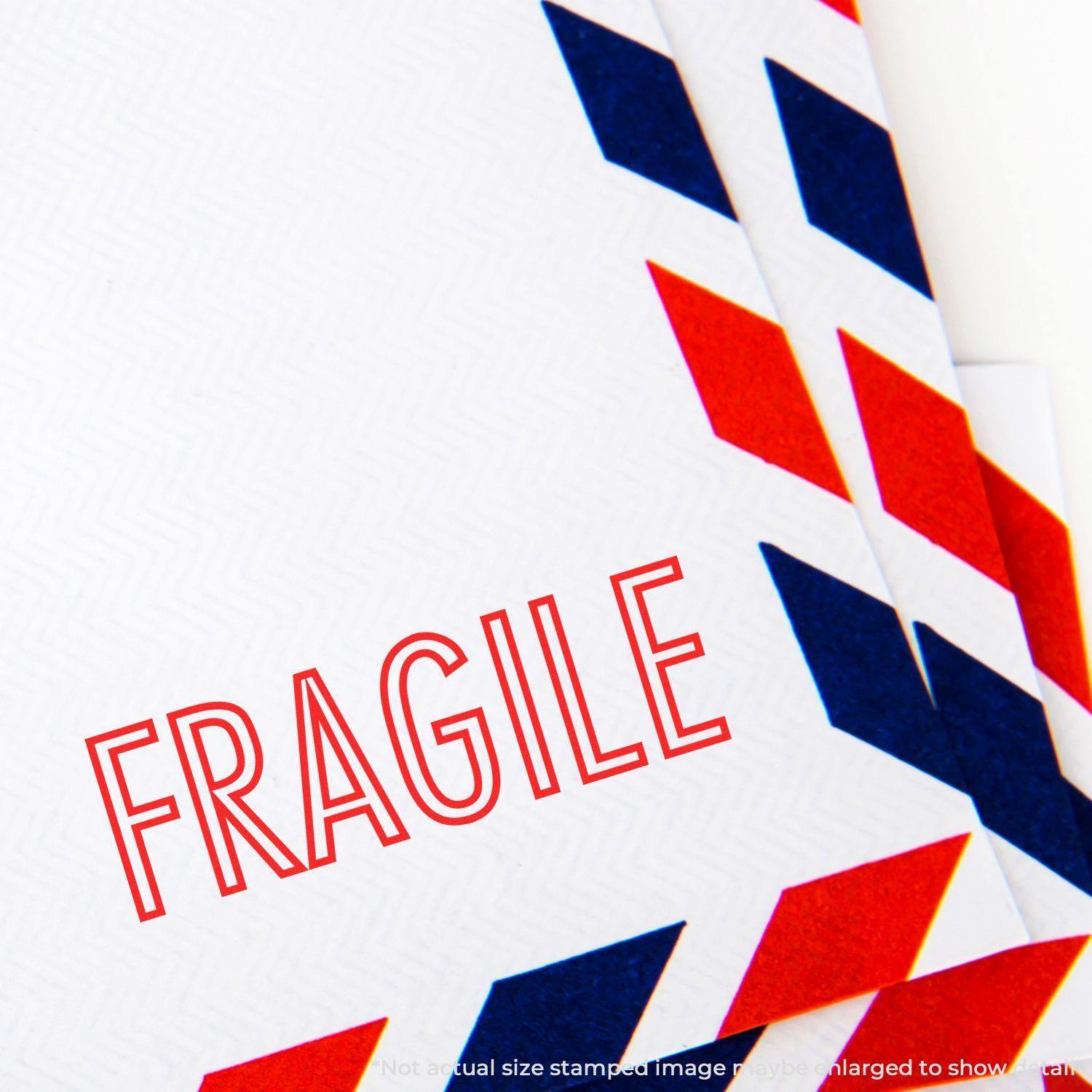 Large Self Inking Fragile Stamp marking a white envelope with red and blue airmail border, emphasizing the word FRAGILE in bold red letters.