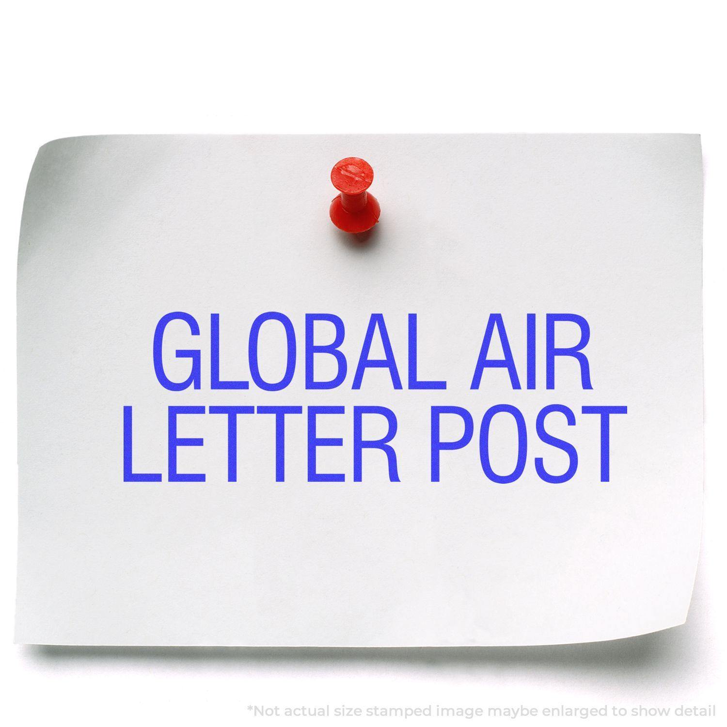 A white paper pinned with a red pushpin, stamped with GLOBAL AIR LETTER POST in blue using the Large Global Air Letter Post Rubber Stamp.