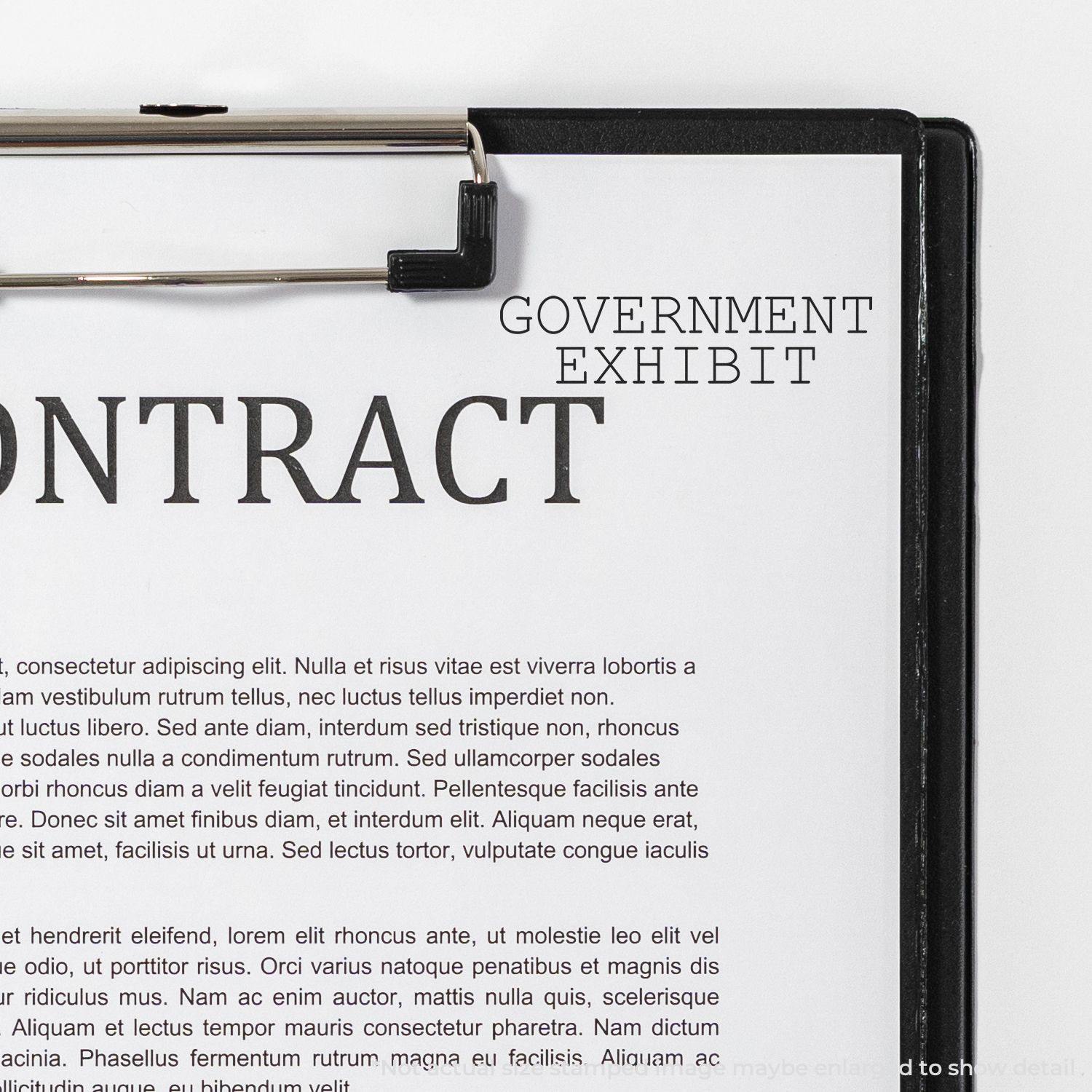 A Large Pre-Inked Government Exhibit Stamp is used on a document titled CONTRACT clipped to a clipboard.