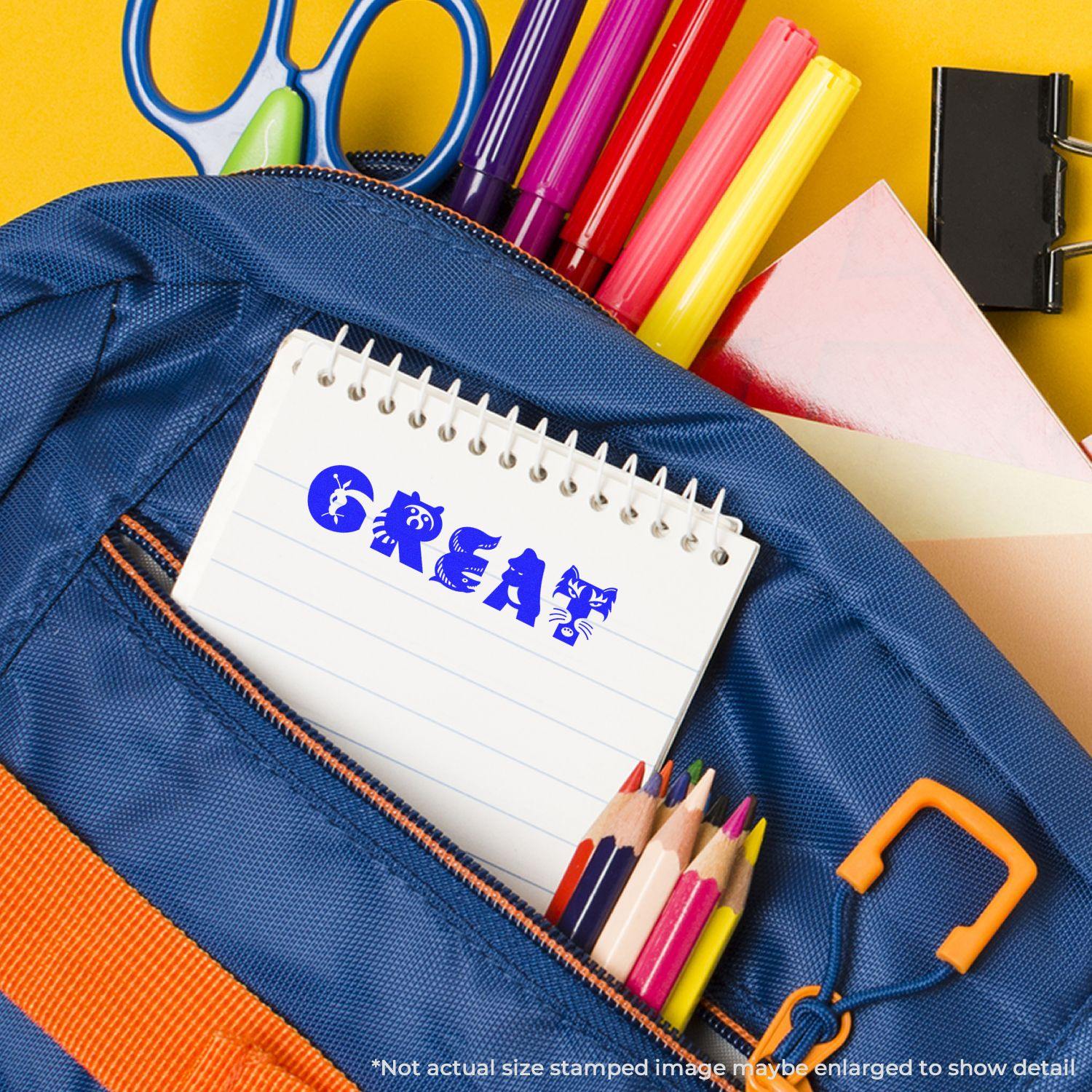 A Slim Pre-Inked Great Stamp is used on a notepad inside a blue backpack with colored pencils, markers, and scissors nearby.