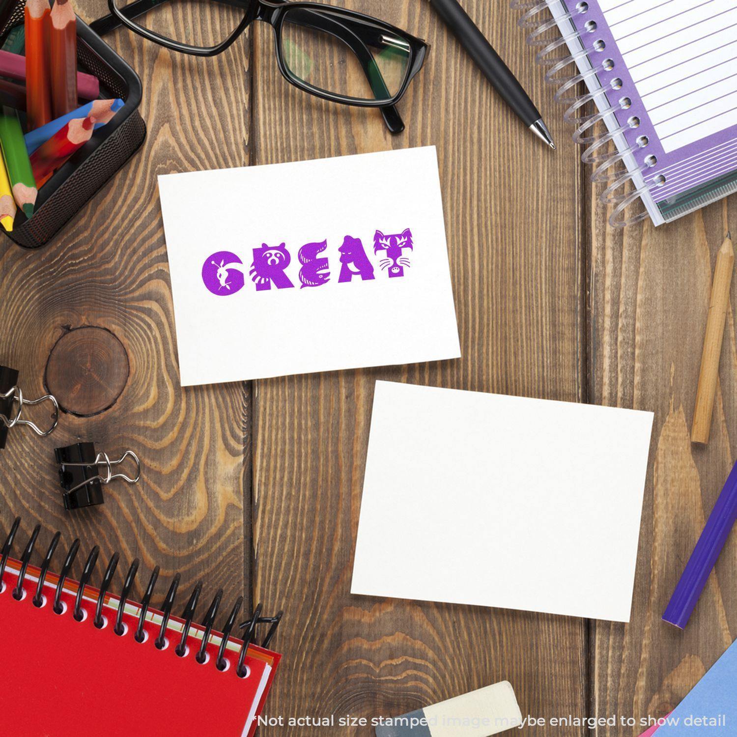 Desk with stationery and a stamped card reading 'GREAT' using a Slim Pre-Inked Great Stamp, surrounded by notebooks and glasses.