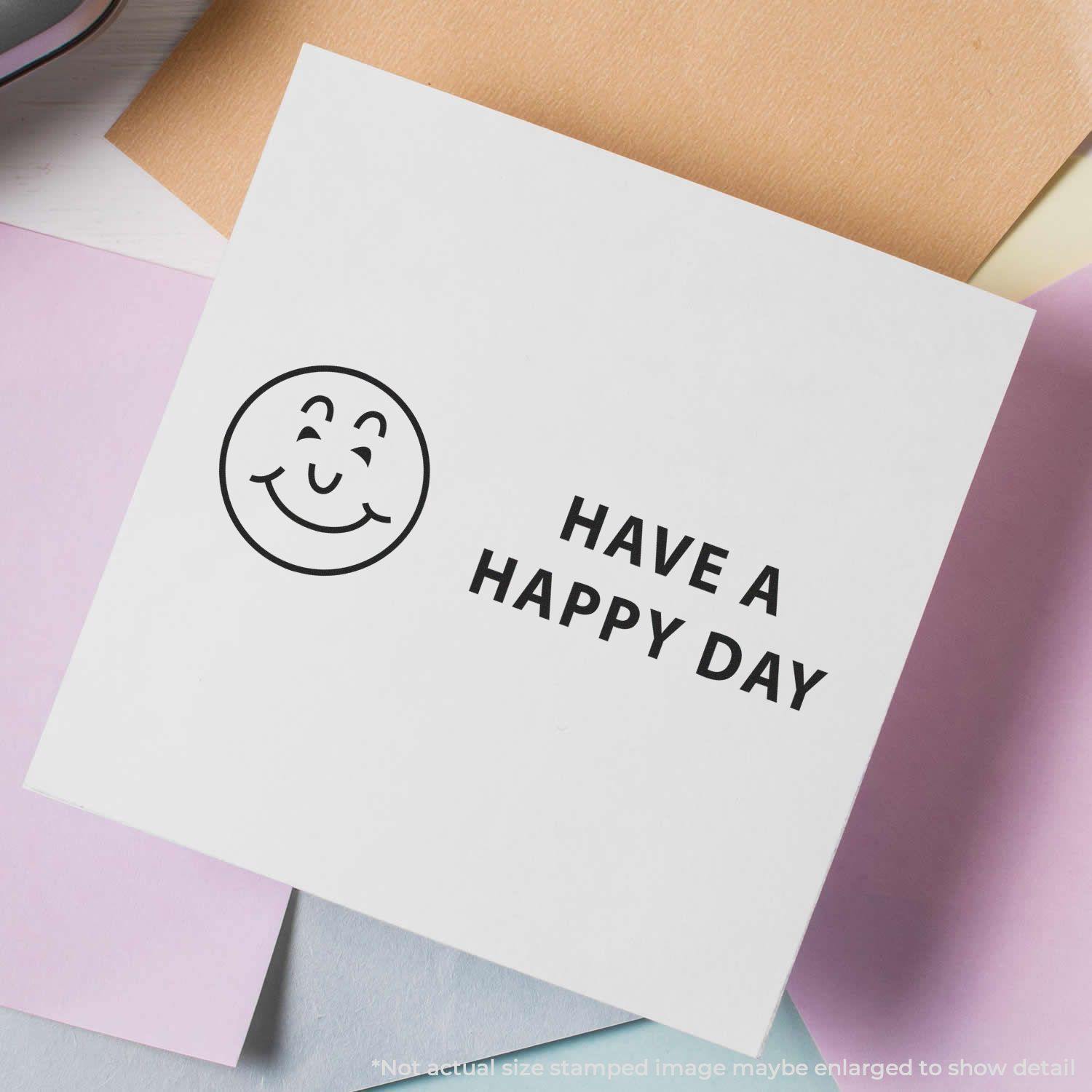 Self Inking Have a Happy Day Stamp on white paper with a smiling face and the text 'Have a Happy Day' surrounded by pastel-colored papers.