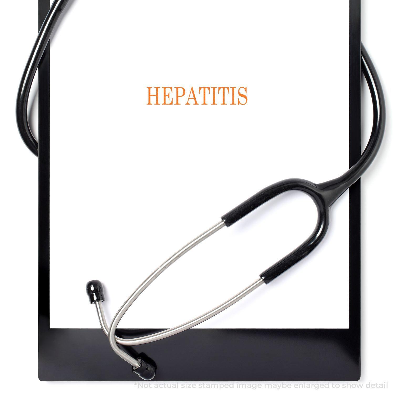 Hepatitis Rubber Stamp in use on a white paper clipped to a black clipboard, with a stethoscope draped around it.