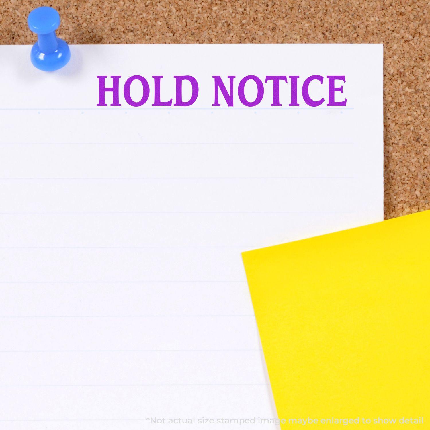 Hold Notice Rubber Stamp in purple ink on white paper pinned to a corkboard, with a yellow sticky note beside it.