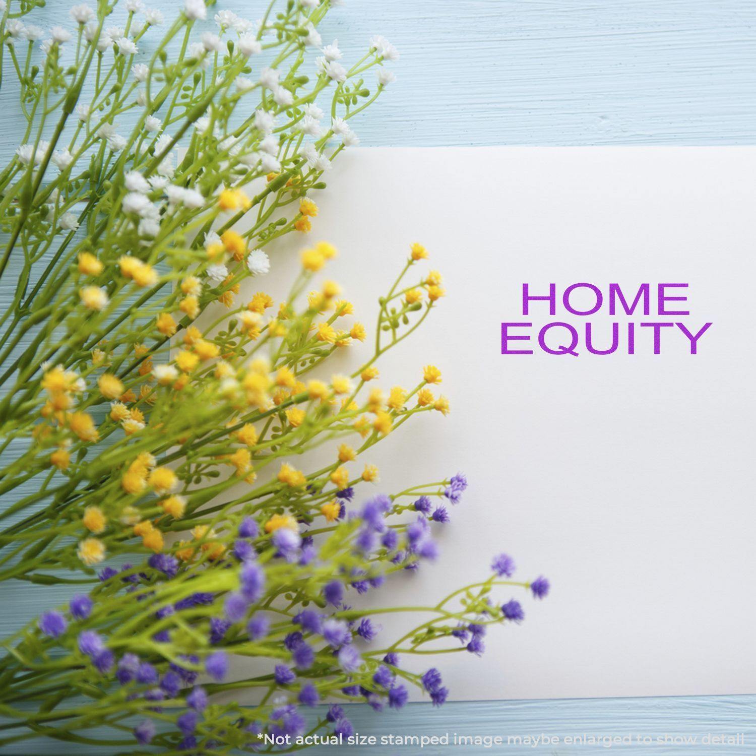 Home Equity Rubber Stamp used on white paper, surrounded by yellow, white, and purple flowers on a light blue wooden surface.