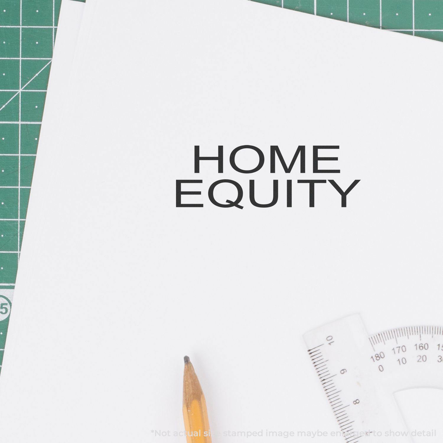 Home Equity Rubber Stamp used on a white paper, with a pencil and ruler nearby on a green cutting mat background.