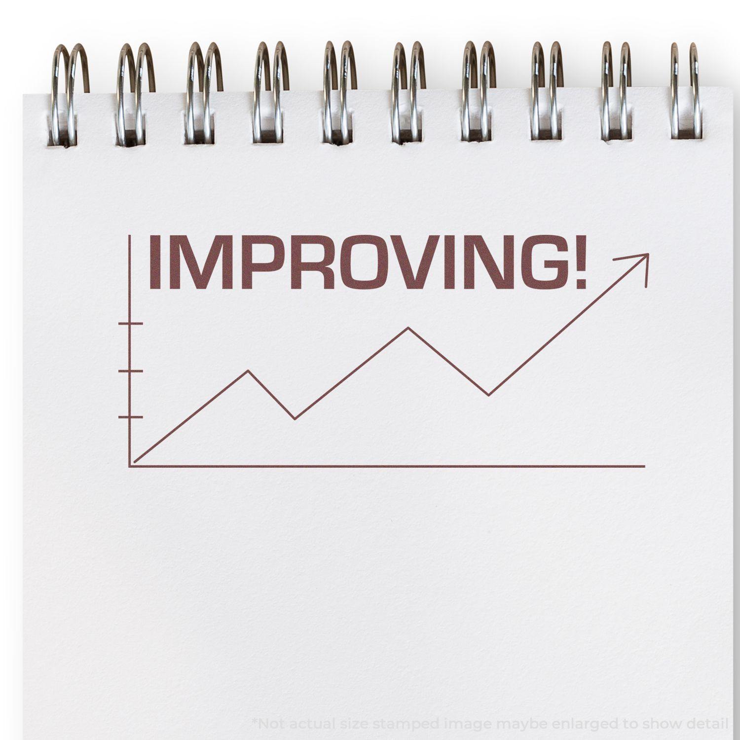 Large Self Inking Improving with Chart Icon Stamp on a notepad, showing an upward trend graph with the word IMPROVING! in bold letters.