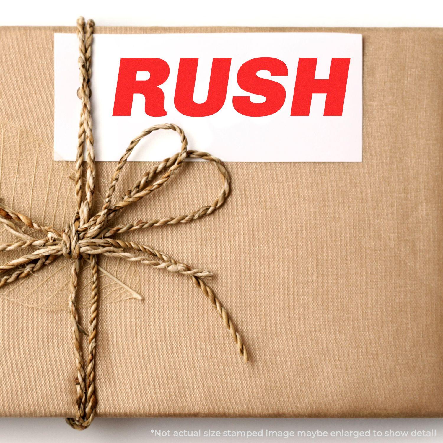 A package wrapped in brown paper with a twine bow, stamped with the _Italic Rush Rubber Stamp_ in bold red letters.