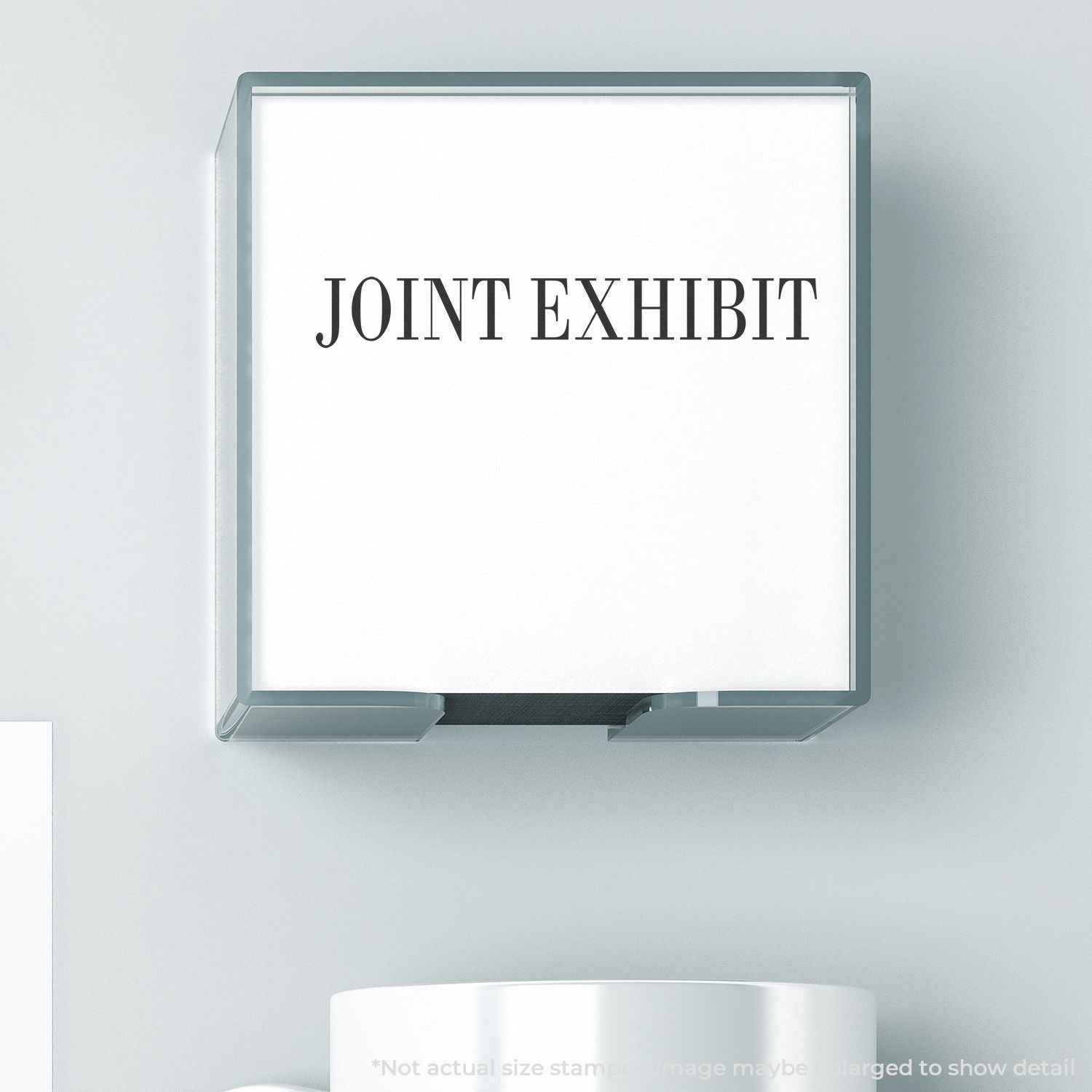 Self Inking Joint Exhibit Stamp in use, showing the clear and bold JOINT EXHIBIT text stamped on a white surface.