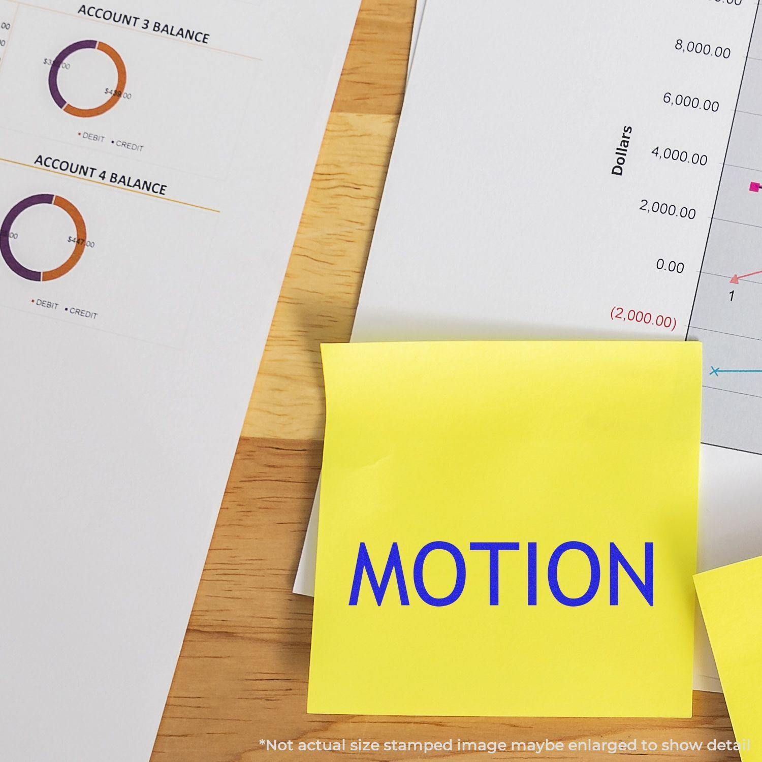 Large Motion Rubber Stamp used on a yellow sticky note, placed on a desk with financial documents and charts in the background.