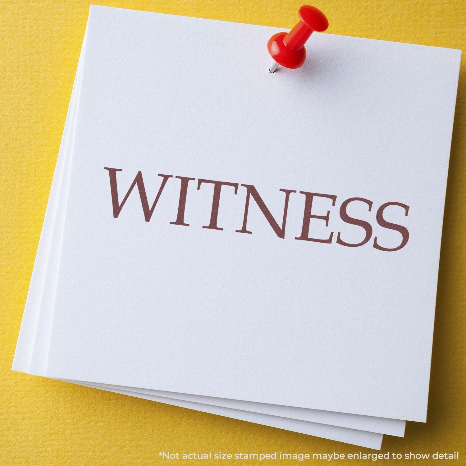 A stack of white papers with the word WITNESS stamped in red using a Self Inking Witness Stamp, pinned with a red pushpin on a yellow surface.