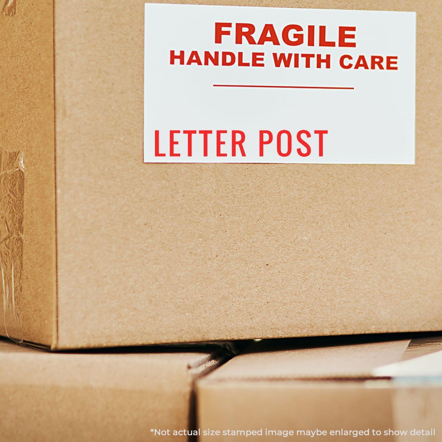 Cardboard box with a FRAGILE HANDLE WITH CARE and LETTER POST label stamped using a Slim Pre-Inked Letter Post Stamp.