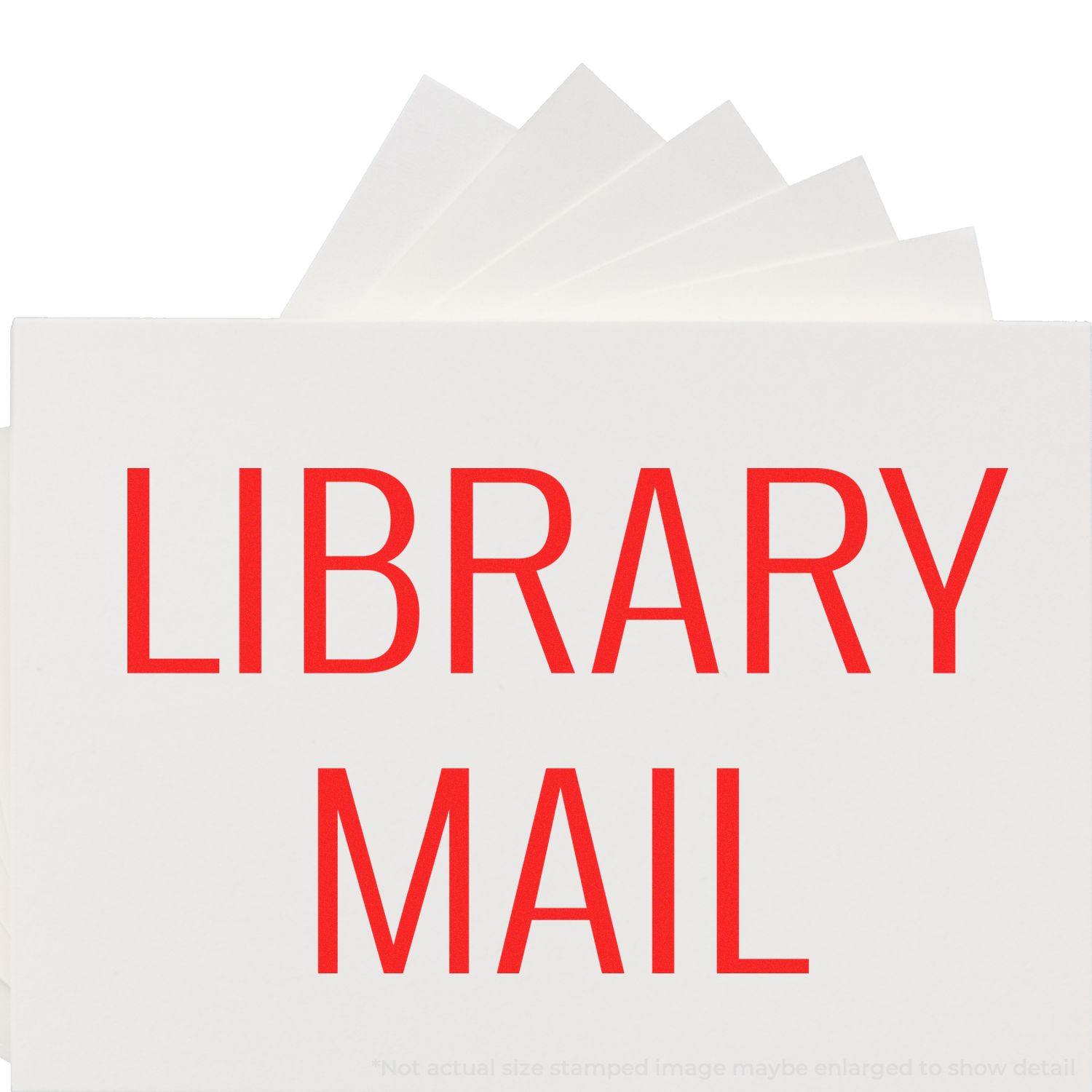 Large Self Inking Library Mail Stamp in use, displaying bold red LIBRARY MAIL text on white paper.