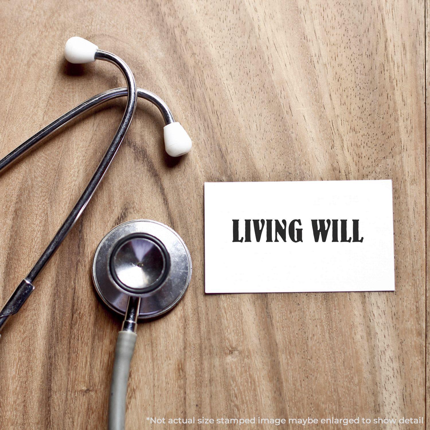 A Large Living Will Rubber Stamp is shown on a wooden surface next to a stethoscope and a card stamped with LIVING WILL.