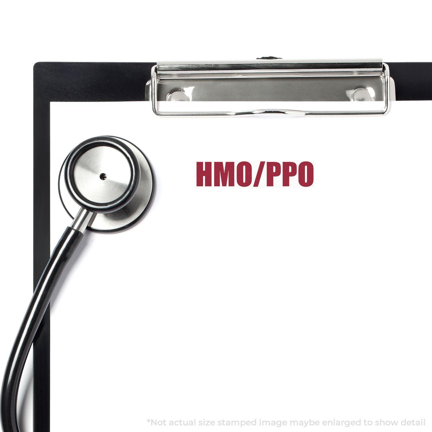 Clipboard with stethoscope and HMO/PPO stamped in red using the Self Inking HMO/PPO Stamp.