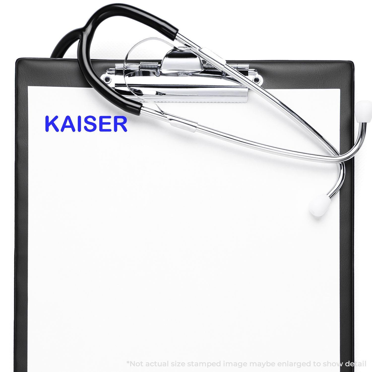 Clipboard with stethoscope and paper stamped with KAISER using the Large Kaiser Rubber Stamp.