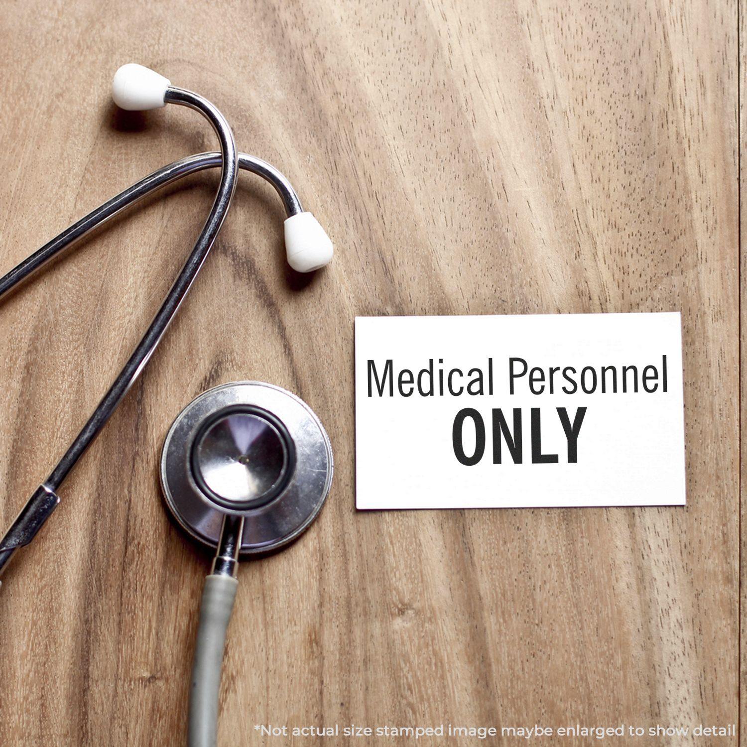 Stethoscope on wooden surface next to a card stamped with Medical Personnel ONLY using a Slim Pre-Inked Medical Personnel Only Stamp.